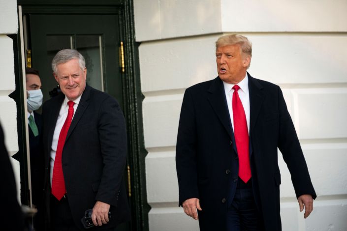 White House Chief of Staff Mark Meadows, left, has said the goal of U.S. President Donald Trump is to &quot;defeat&quot; the coronavirus, not &quot;control&quot; it. (REUTERS/Al Drago)