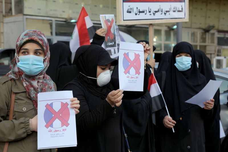 Iraqi people gather during a protest against the publications of a cartoon of Prophet Mohammad in France and French President Emmanuel Macron's comments, outside the French embassy in Baghdad